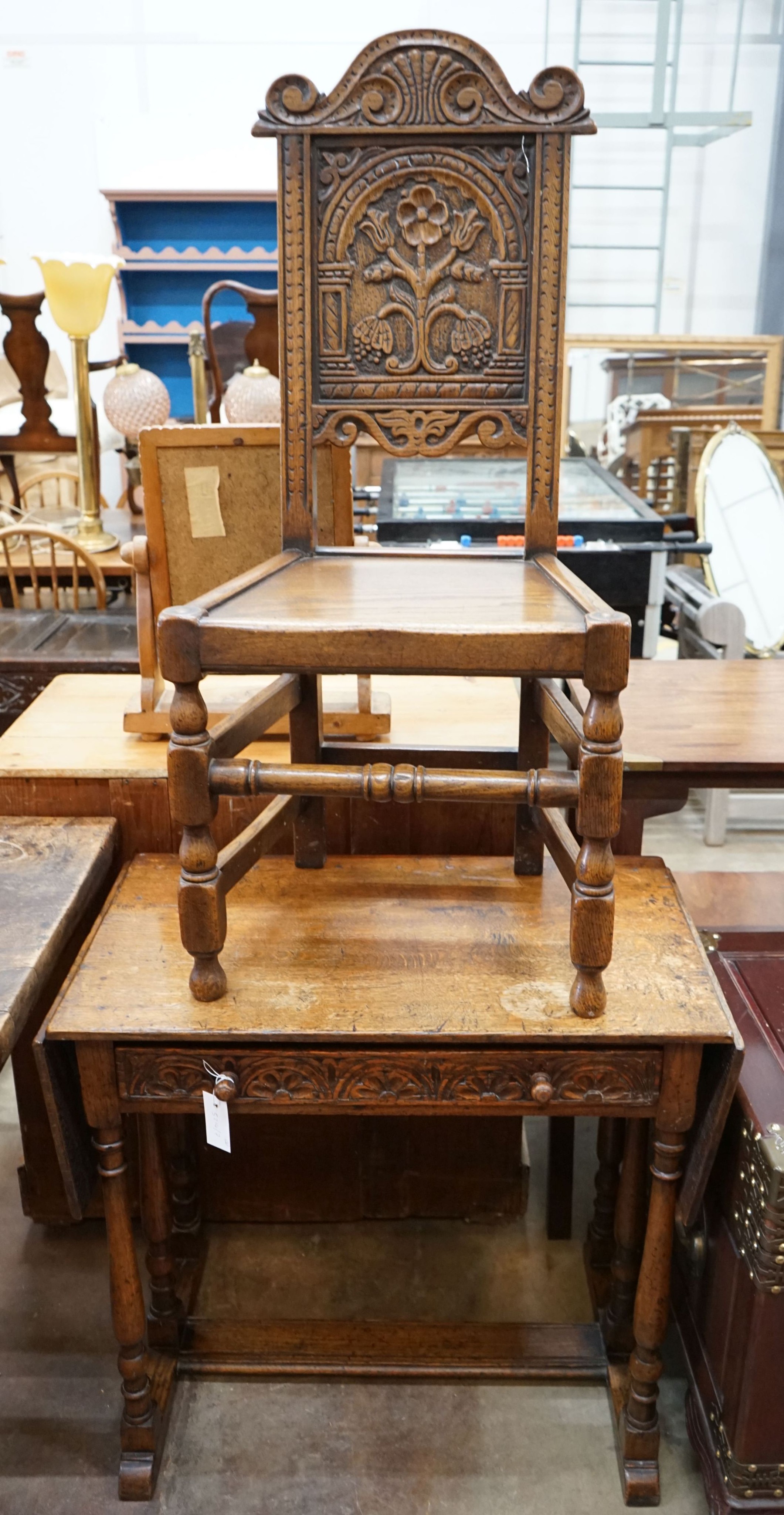 A 17th century style oak drop-leaf side table, width 79cm, depth 45cm, height 74cm together with a carved oak side chair